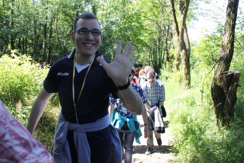 a group of people walking down a forest