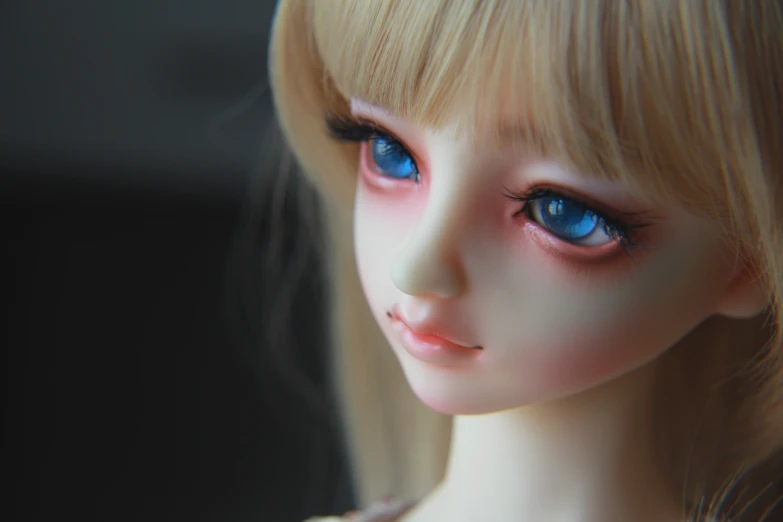 a doll has blue eyes and blonde hair