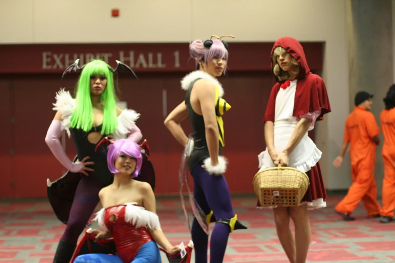 group of costumed women in a room with other costumed people