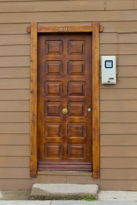 a wooden door is open on a house