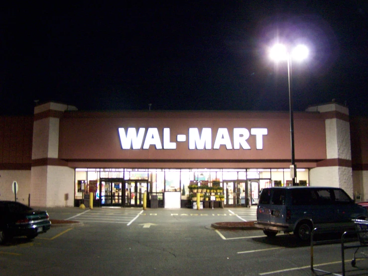 a walmart store lit up at night time