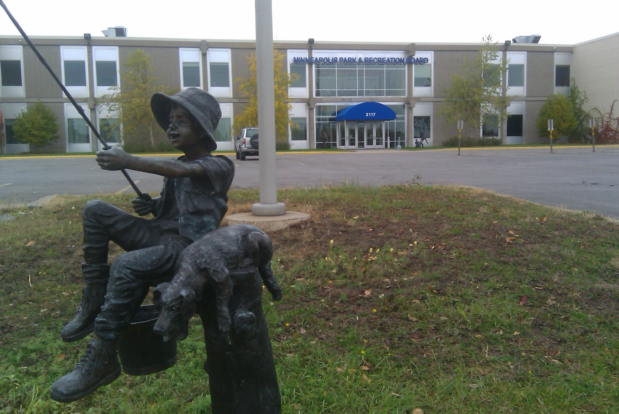 a statue of a man on top of a horse holding a fishing rod