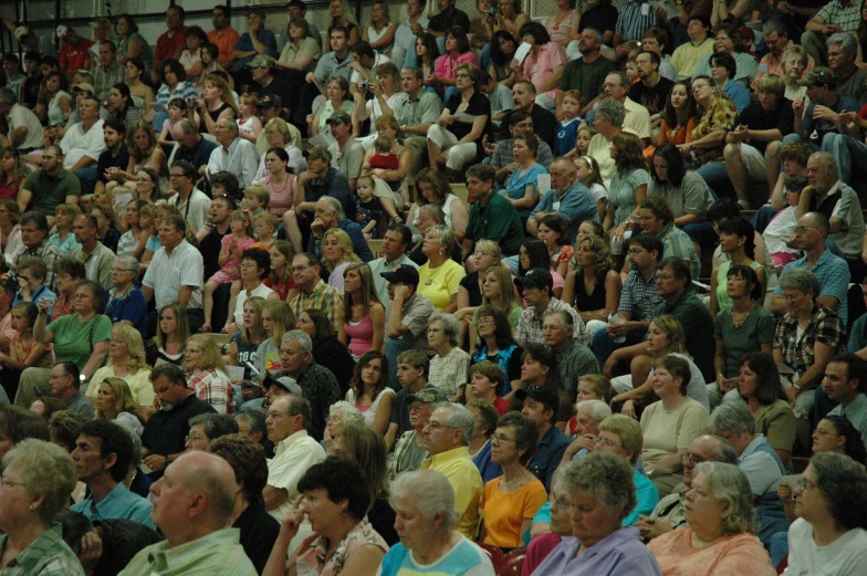 a large group of people with their hands up