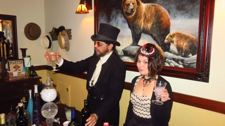 man and woman in black outfits drinking drinks