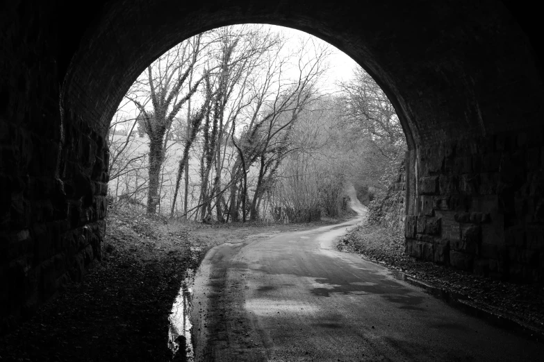 an old stone tunnel way in black and white