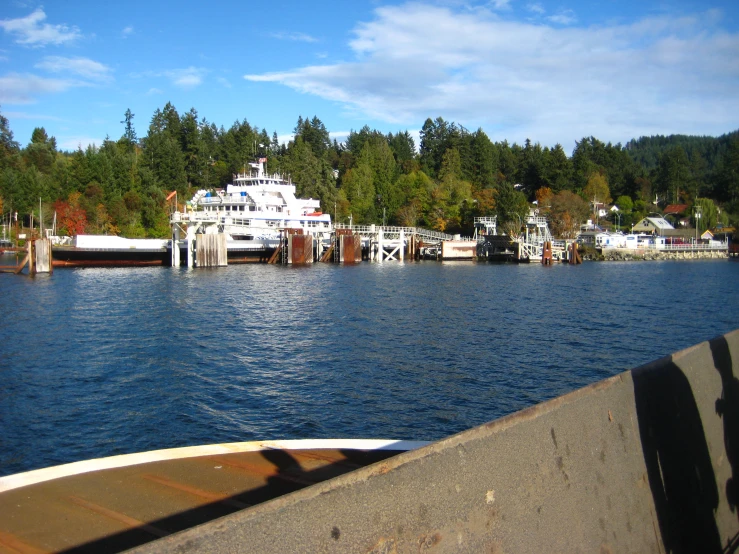 a ferry boat at dock and docked in a beautiful, peaceful area