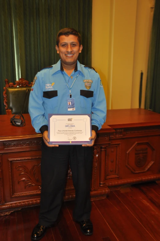 a man with an award in front of his name