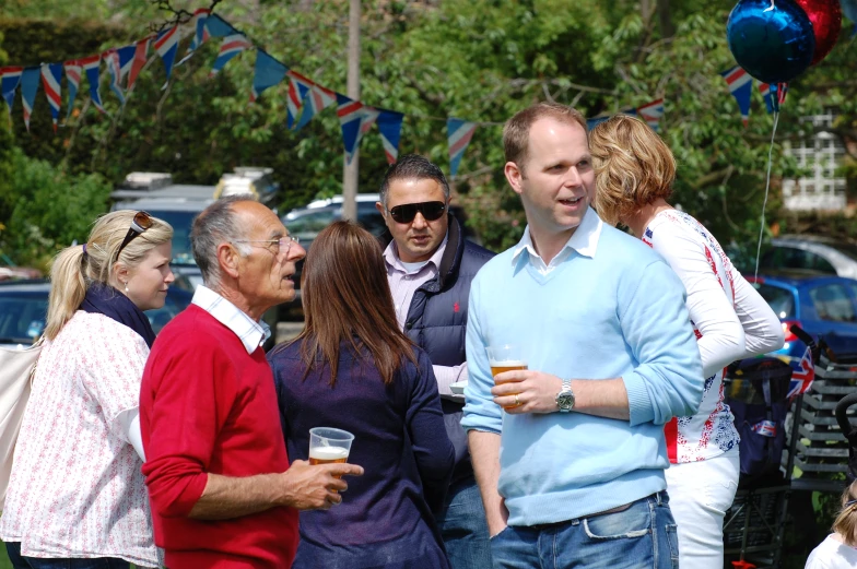 people are enjoying a drink at an outdoor gathering