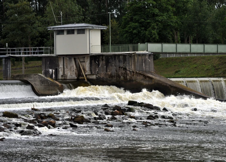 the water is rushing into the reservoir at the base of the dam