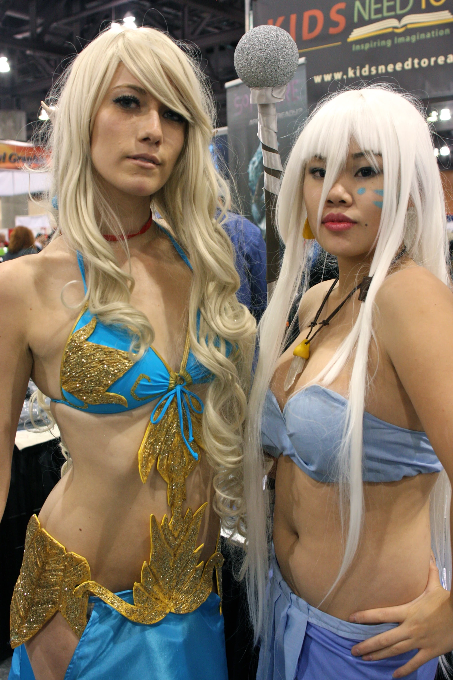 two women standing next to each other at a trade show