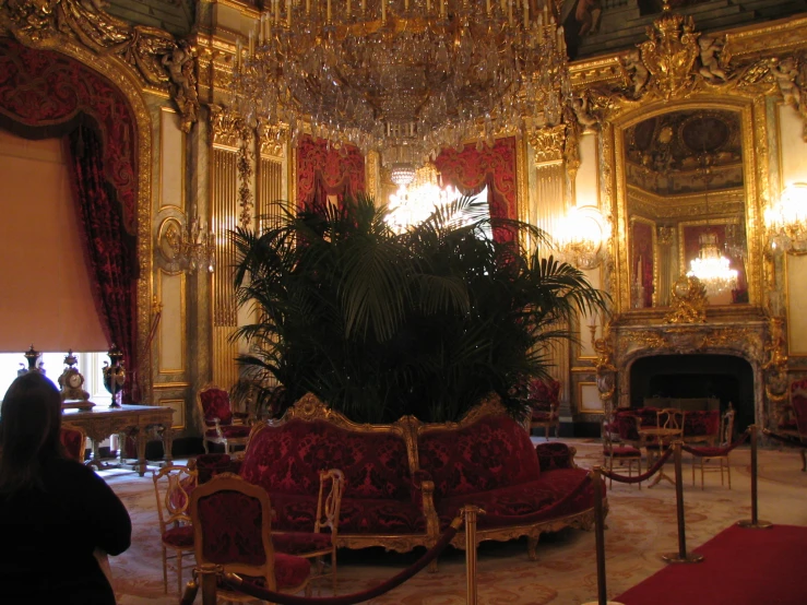 a large room with chandeliers and red velvet seating