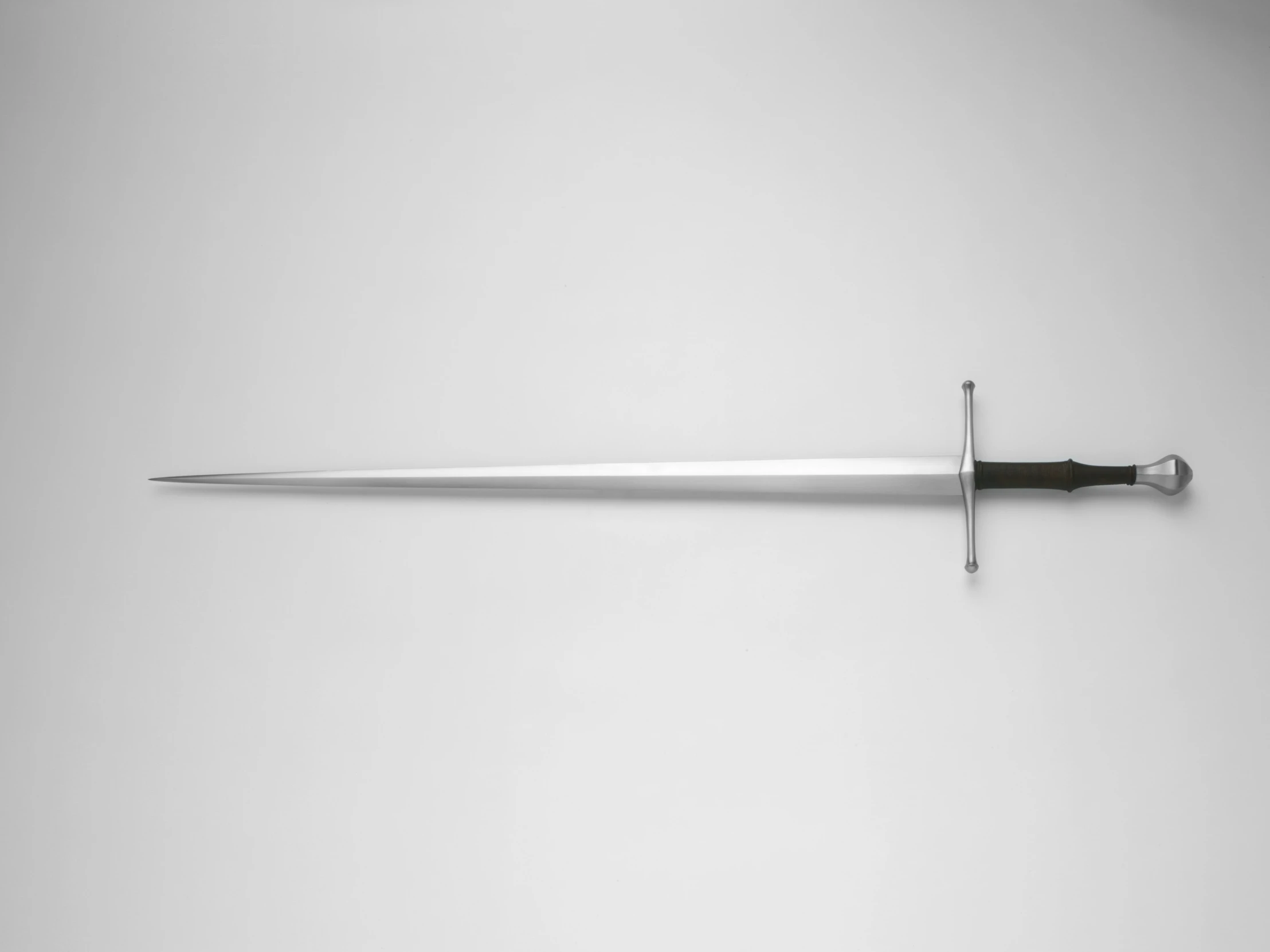 a sword in a museum display hanging on the wall