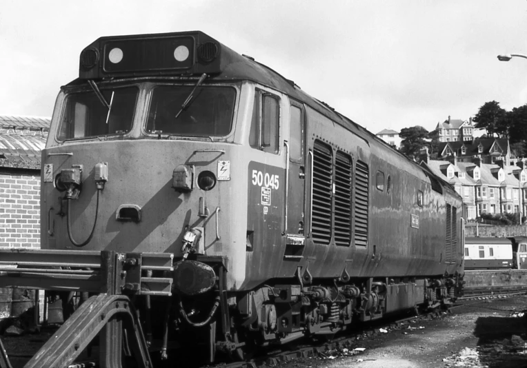 a old train car sits alone on the tracks