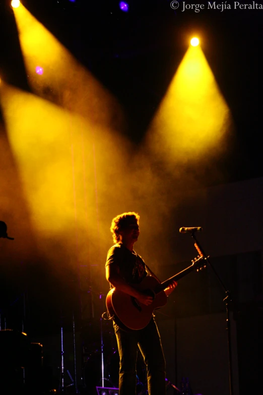 a man that is playing a guitar on stage
