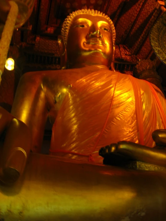 a large golden buddha statue in a temple