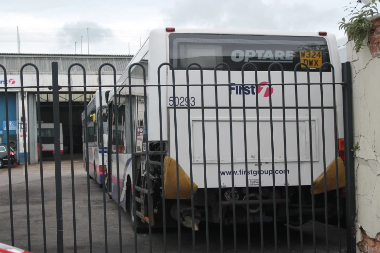 a small truck behind the fence in a parking lot