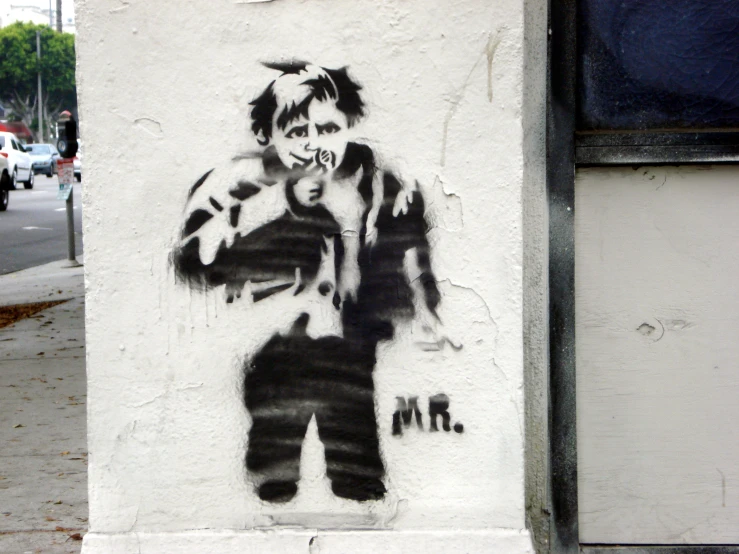 a black and white graffiti painting on the side of a building