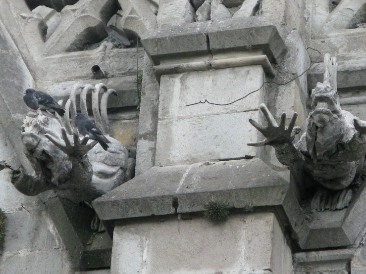 an intricate statue on top of a stone building