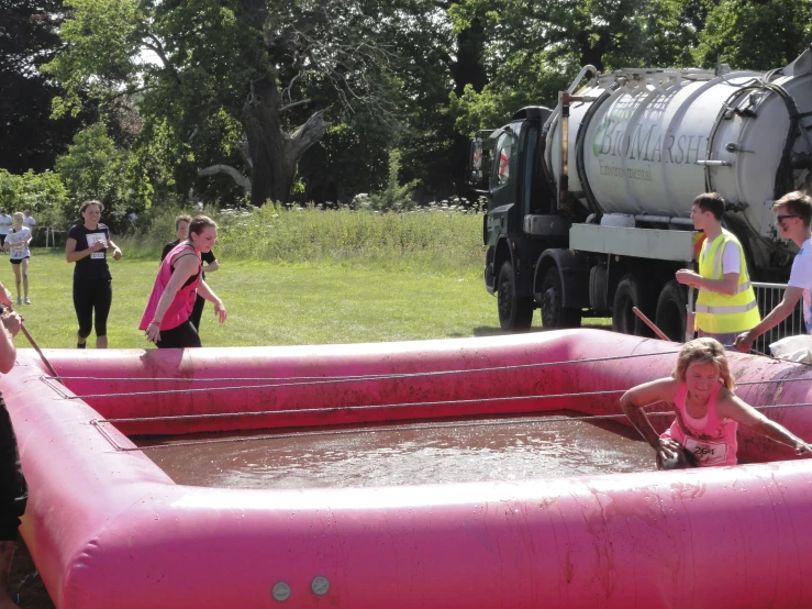 children having fun playing in an inflatable pool