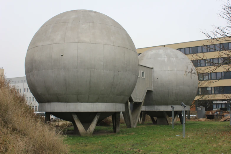 giant grey balls with a small window in the middle of a large building