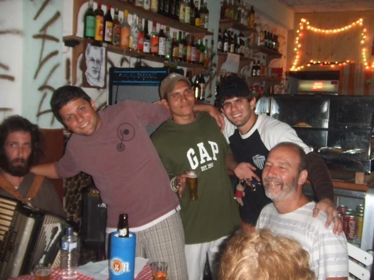 four men in a restaurant posing for the camera