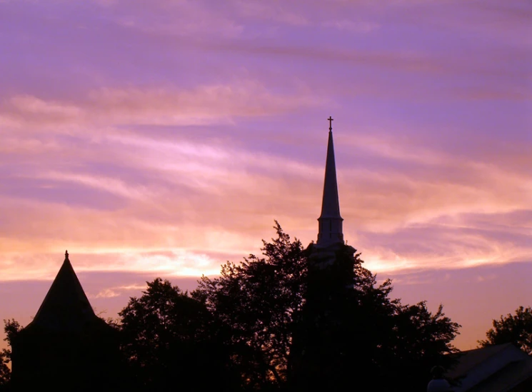 a steeple against the sky at dusk