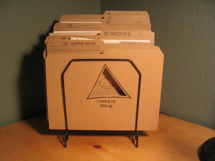 a cardboard box filled with folders sitting on a table