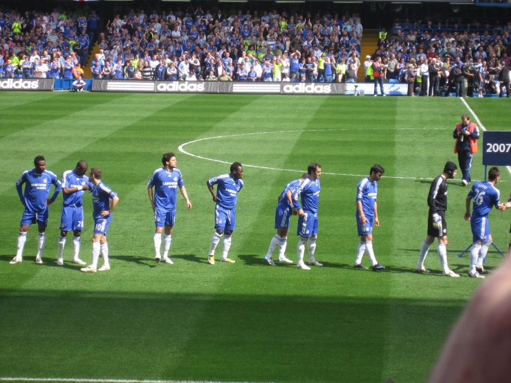 a team of people are on a soccer field