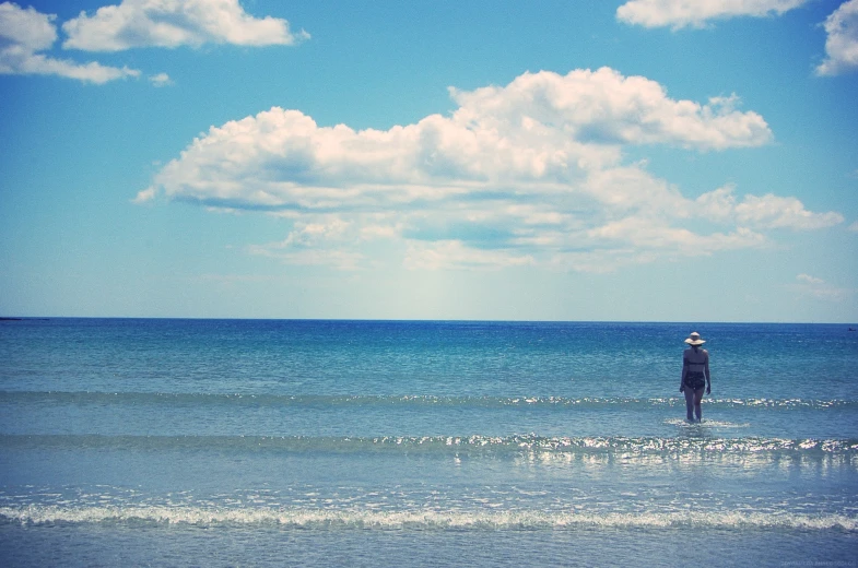 a man standing in the water near an ocean