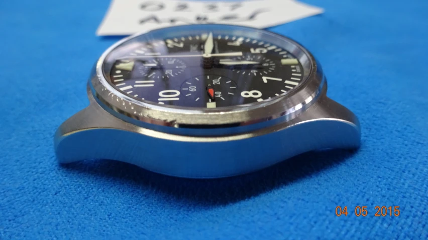 a blue watch with an analog setting on top of it