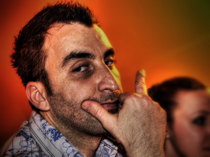 an image of a man staring with his finger to his mouth