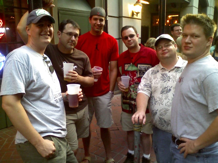 a group of people are posing with cups