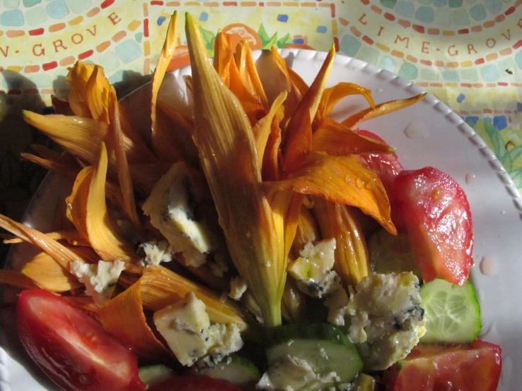 a plate of food including vegetables, carrots and cheese