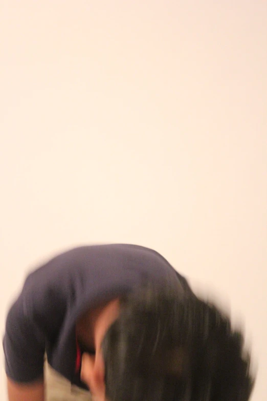 a blurry image of a person with head down