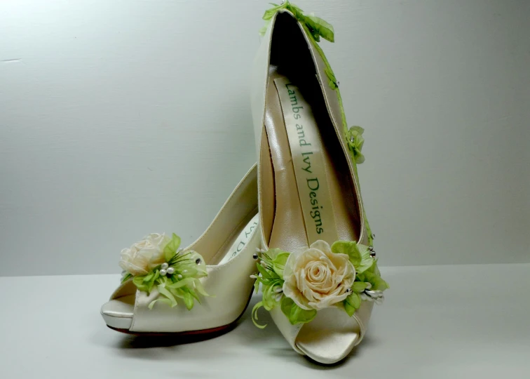 a pair of wedding shoes with flower decorations