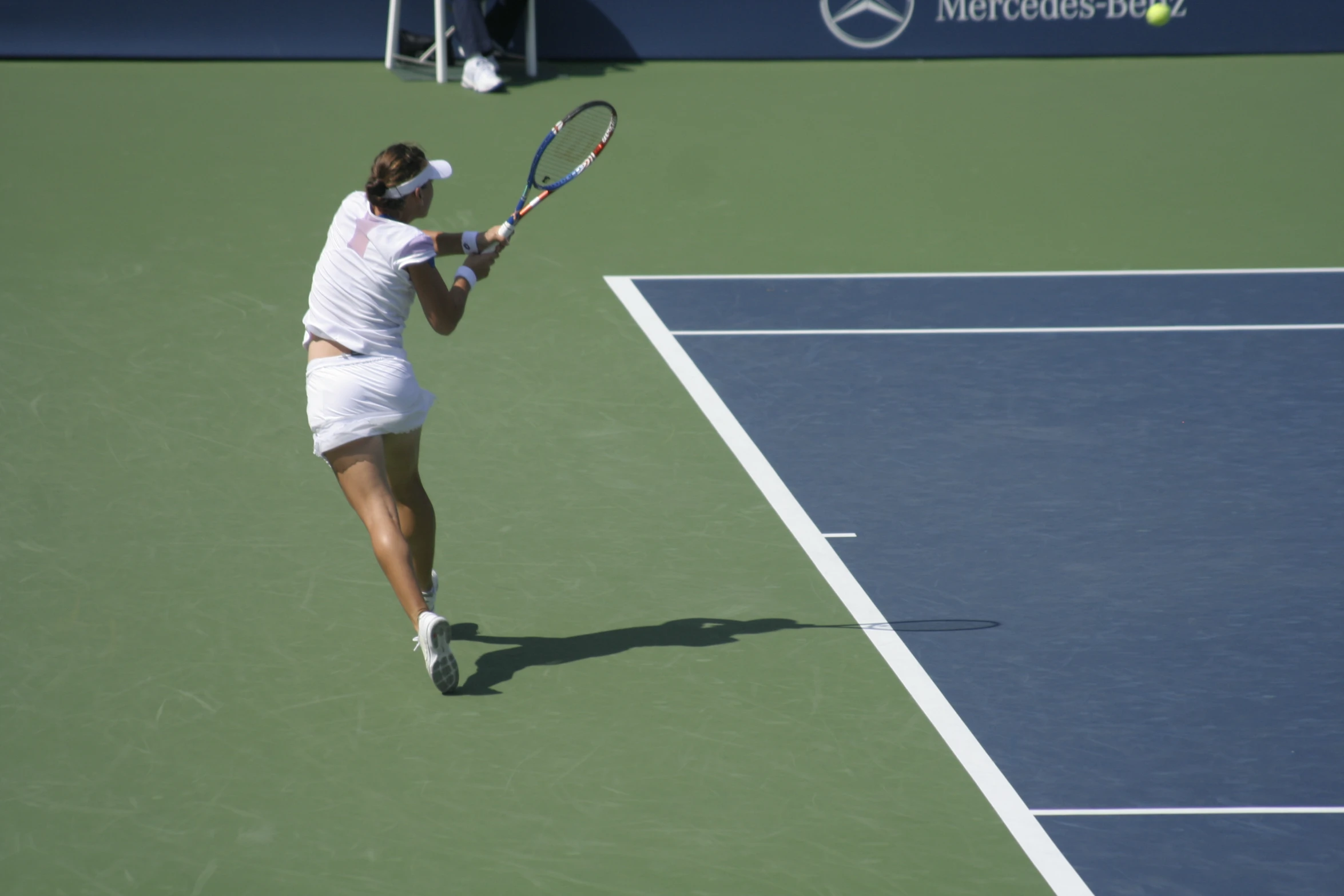 a female tennis player in action on the court