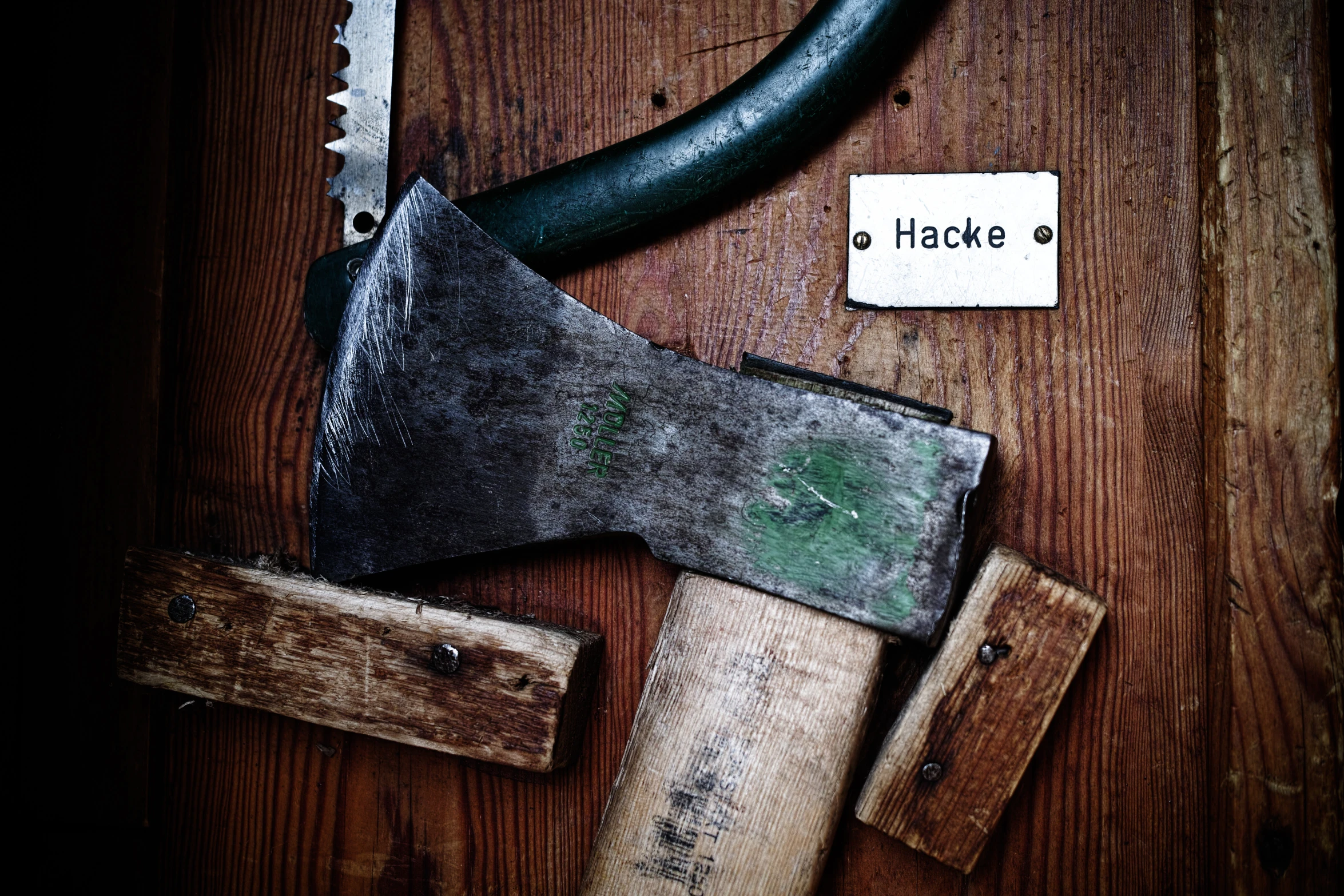 an axe and hammer lying on a wooden floor