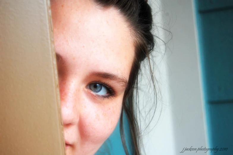 a close up of a young woman's blue eyes