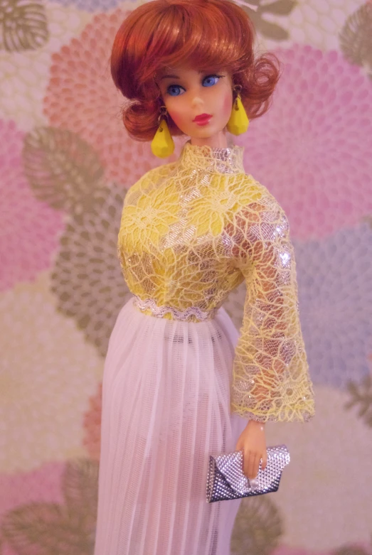 a doll is dressed up and holding a purse