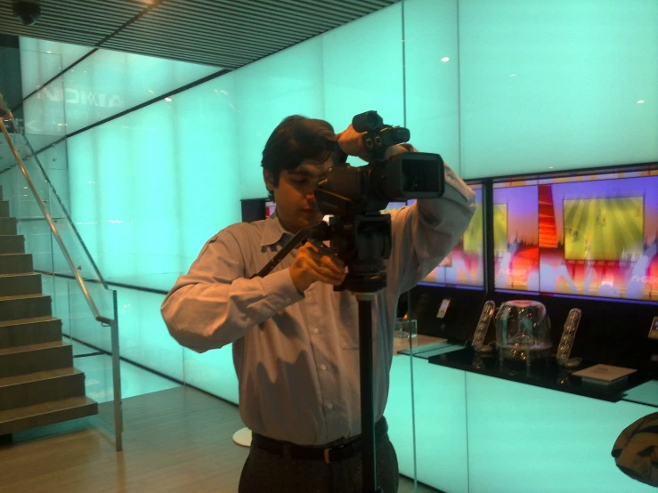 a man taking a picture of some jewelry on display