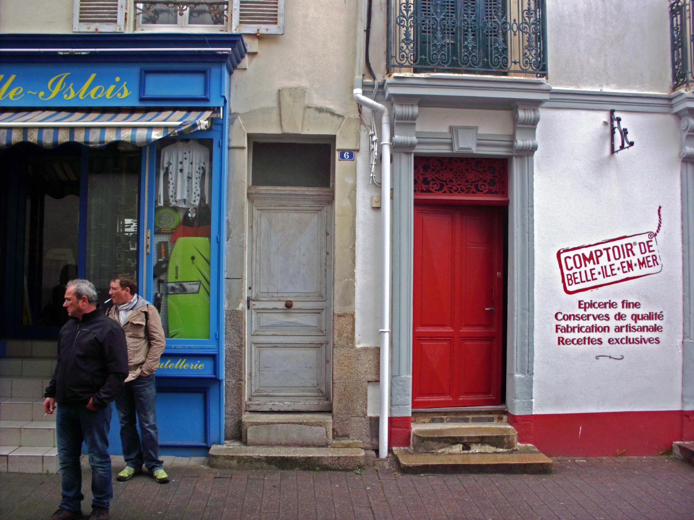 two men standing in front of a building