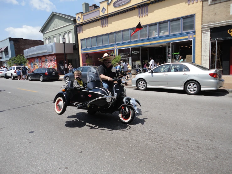 a person riding a motorcycle with the sidecar down the street