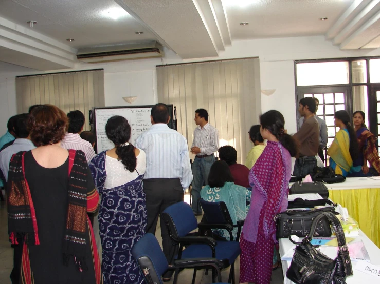 people standing in a group in front of a table