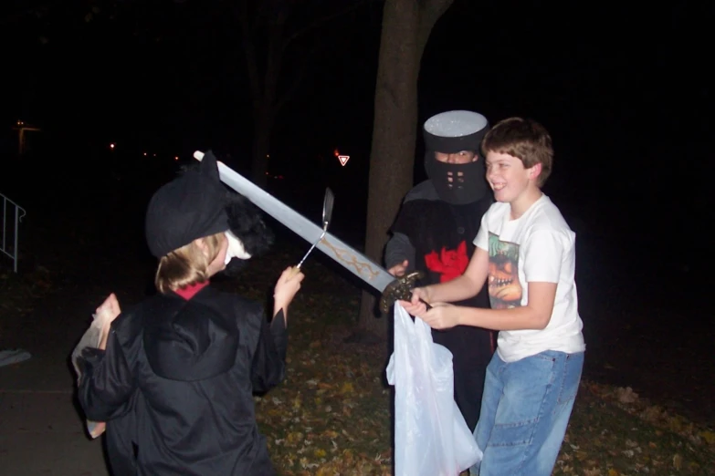 a young person holding up a sword to another man