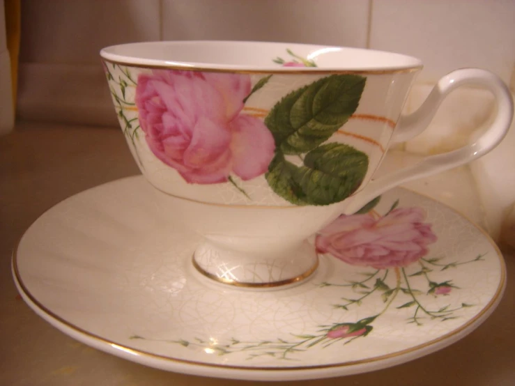 an image of cup and saucer on a plate