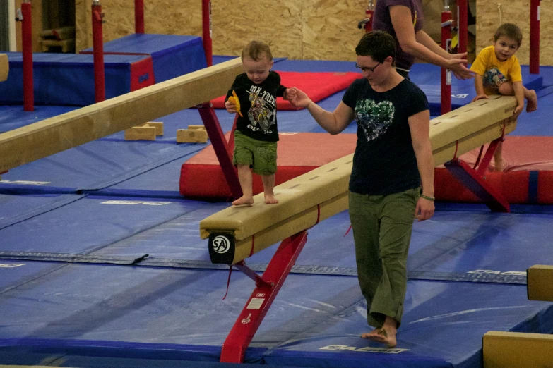 a man walks across the top of an obstacle course