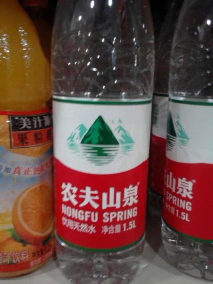 two bottles with drinks in front of each other
