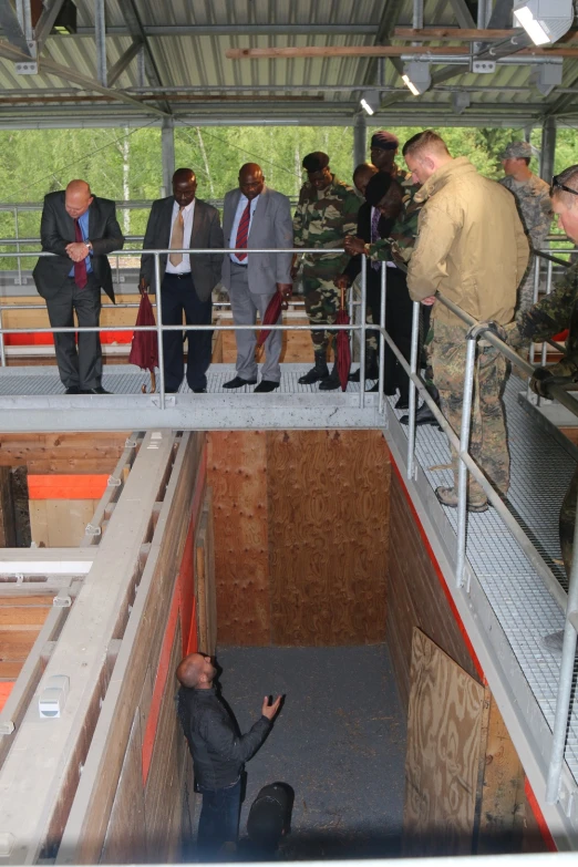 the group of men are standing inside a building