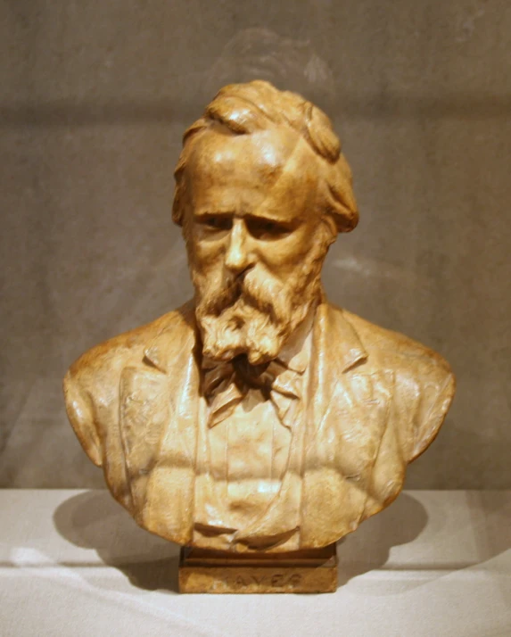 the bust of a man in a formal suit