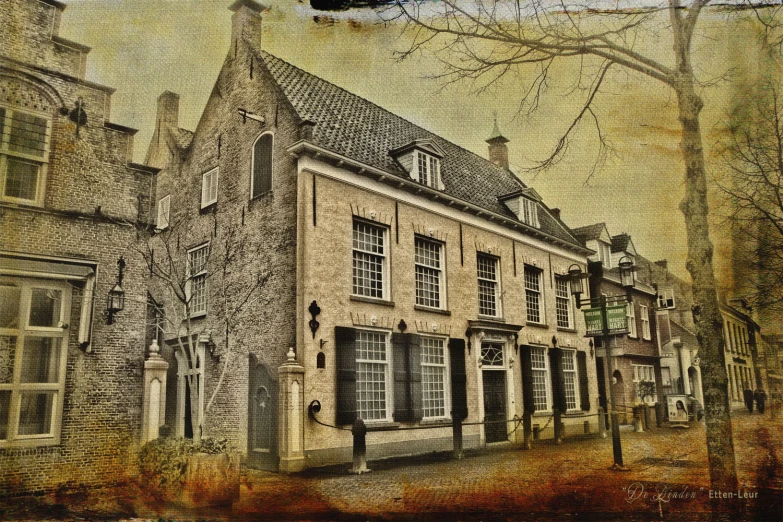 an old building sitting next to tall trees and brick houses